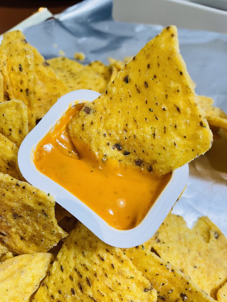 close-up of nacho chip coated in sauce appealing to buy korean snacks online readers