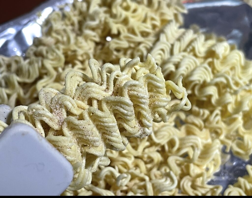 a close-up view of the ramen texture. the crisp surface and visible seasoning grains make it ideal for a korean snack review image