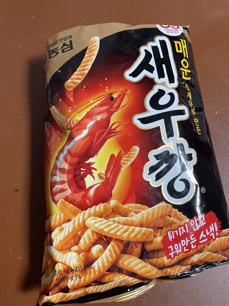 front view of maewoon saewookkang with red shrimp illustration and bold korean logo, showing spicy korean snack flavors