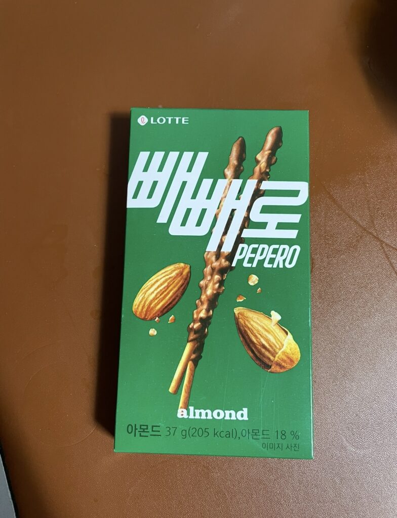 Front package of pepero almond featuring its signature chocolate-coated almond sticks, clearly showing the product’s design and branding