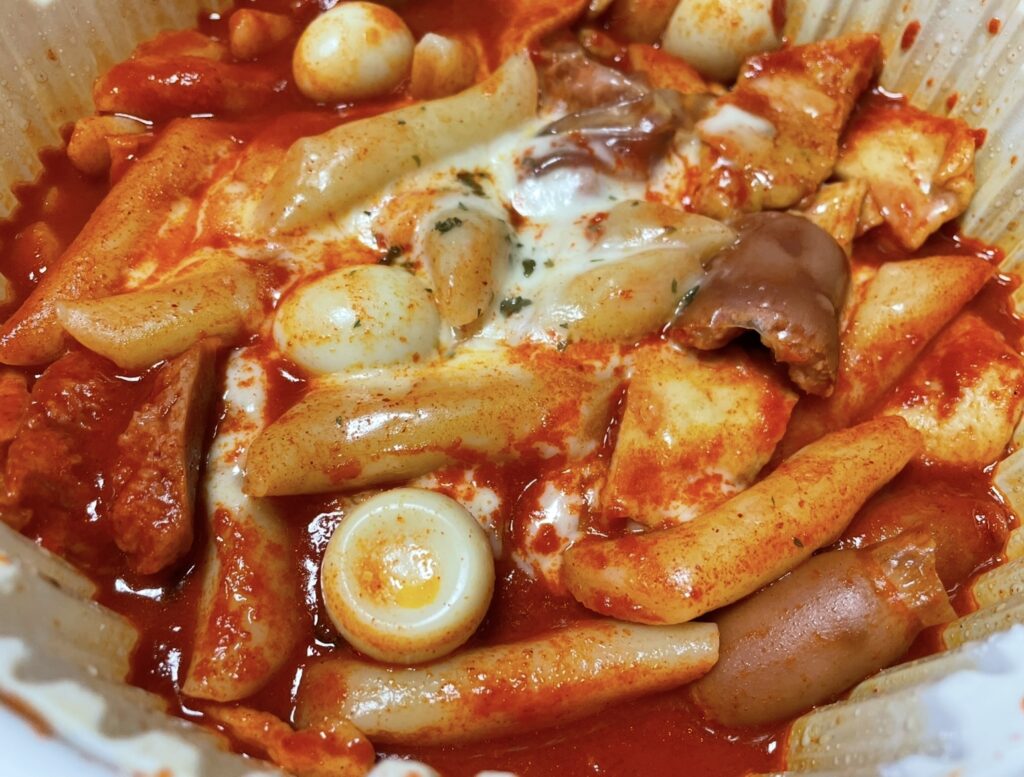 a shot of the actual dal tokki tteokbokki mild pieces inside the opened bag, naturally showing the amount and shape for those searching for where to buy korean snack.