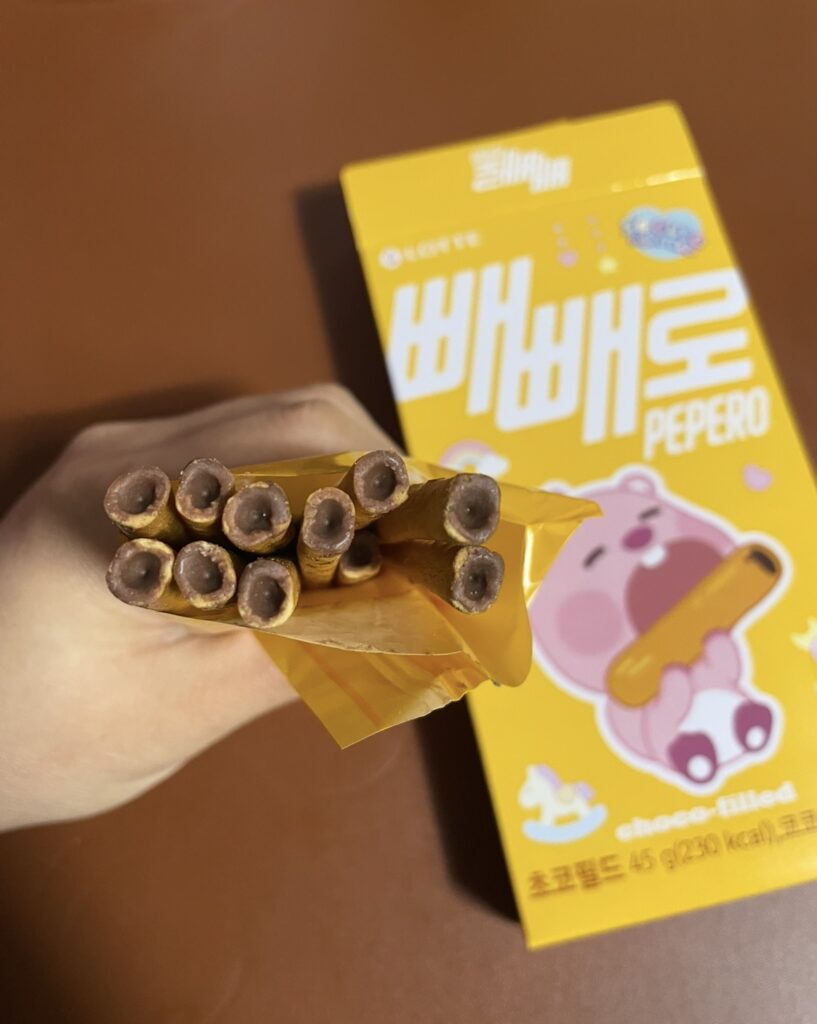 Close-up shot of a Pepero Choco Filled stick, capturing the texture and chocolate filling, suitable for detailed use in a Korean snack review