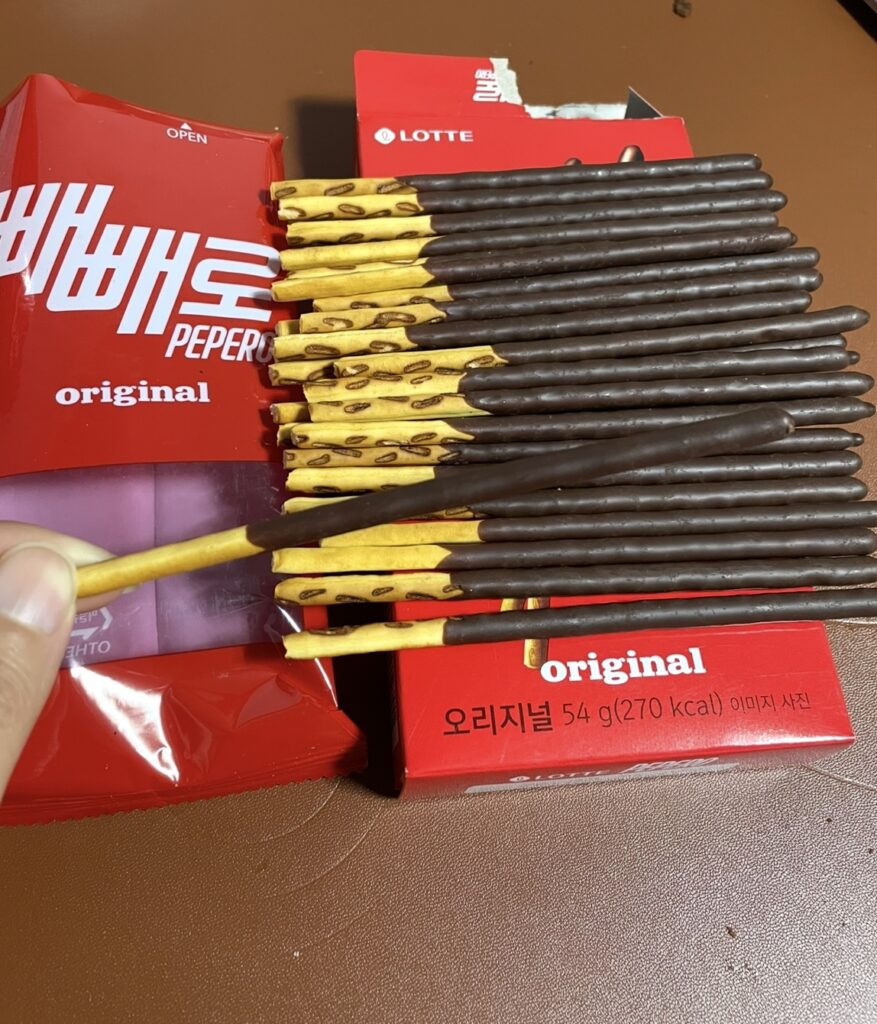 Close-up shot of a Pepero Original stick with visible chocolate texture, suitable for detailed use in a Korean snack review