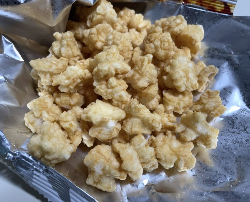 the yellowish, irregular pieces are visibly coated with seasoning, encouraging consumers to buy korean snacks online for this treat.