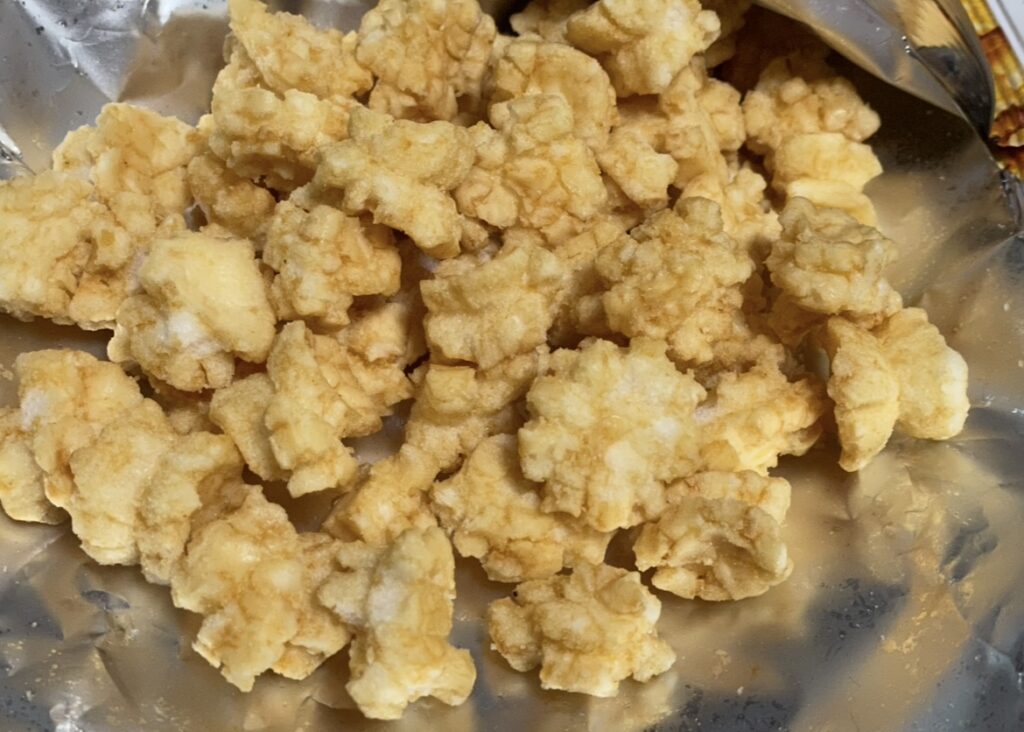 the close-up view clearly shows the porous, puffed texture of the ssallobyeol, promising a light and crispy bite.