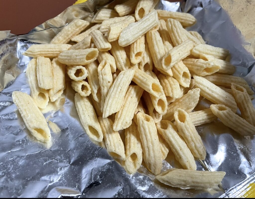 the snack pieces spread out to show their uniform shape and roasted brown color, helping describe the overall texture and style among various korean snack flavors.