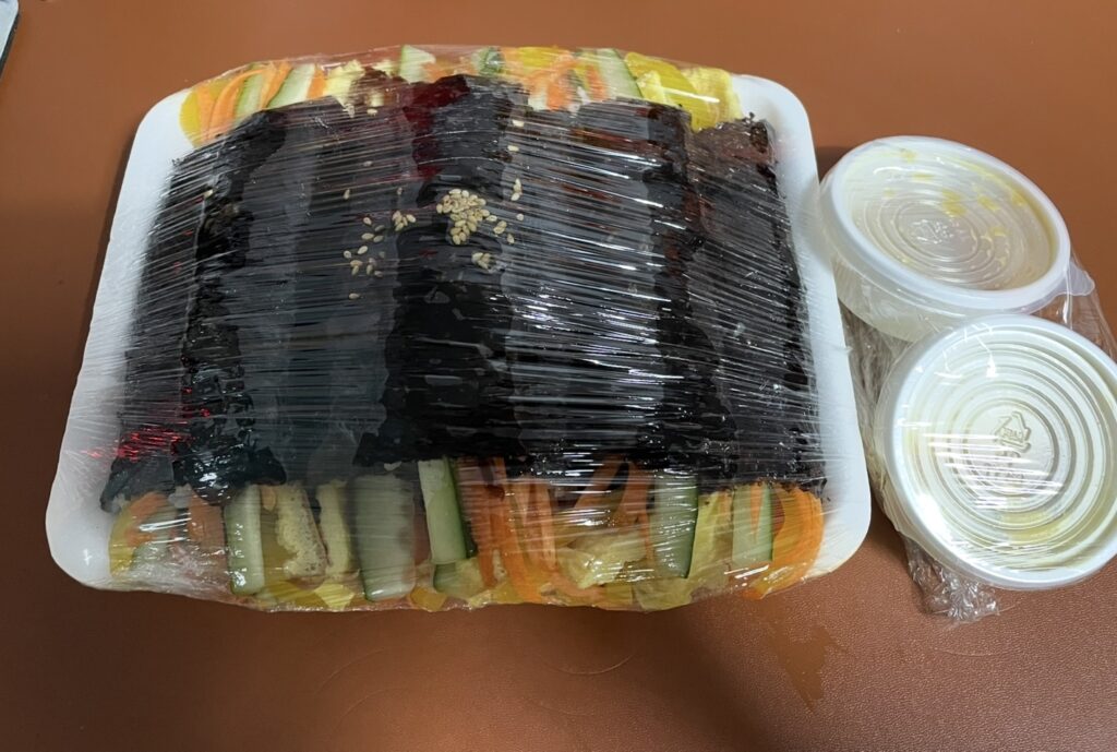 a full front view of the bupyeong kkoma gimbap package, highlighting the neat and simple design typical of kkoma gimbap