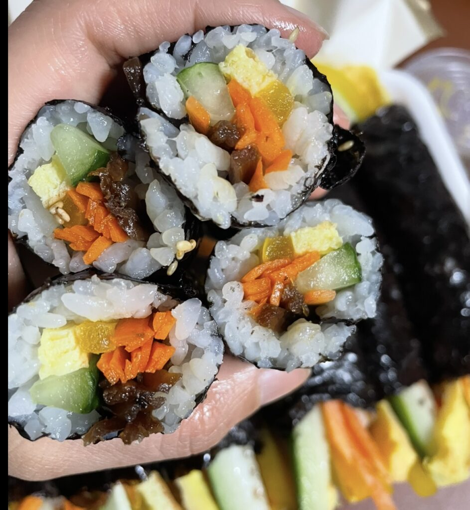 a second close-up image focusing on the texture and shine of the small rolls, reflecting the simple and savory style of korean sush