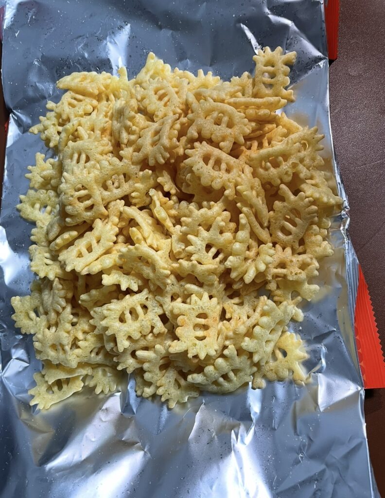 The open bag and the spread-out, crispy Kkotgerang Original crackers, suggesting where to buy korean snac