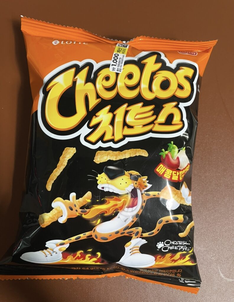 a clear shot of the cheetos spicy sweet front package, showing the bright orange and black design and the overall look of the snack